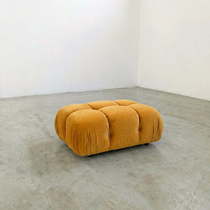 mustard camaleonda ottoman alternative on a concrete floor with white walls