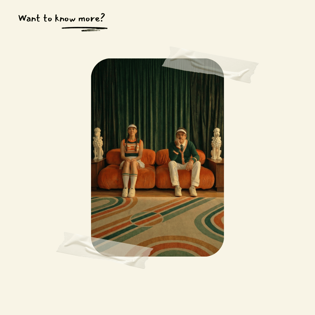 Two people sitting on an orange camaleonda couch dupe in a room with decorative elements.