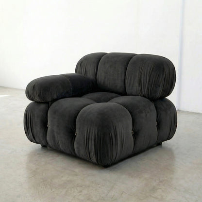 Dark Grey camaleonda armchair dupe on a white floor with a white wall background