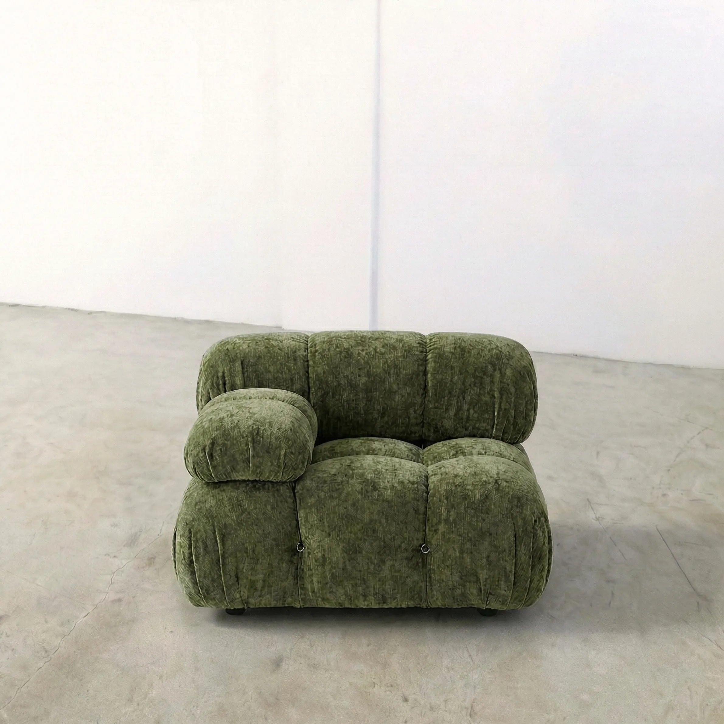 Camaleonda modular sofa section alternative with right armrest in green chenille on a gray floor with a white wall background
