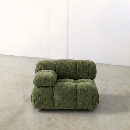 Camaleonda modular sofa section alternative with right armrest in green chenille on a gray floor with a white wall background