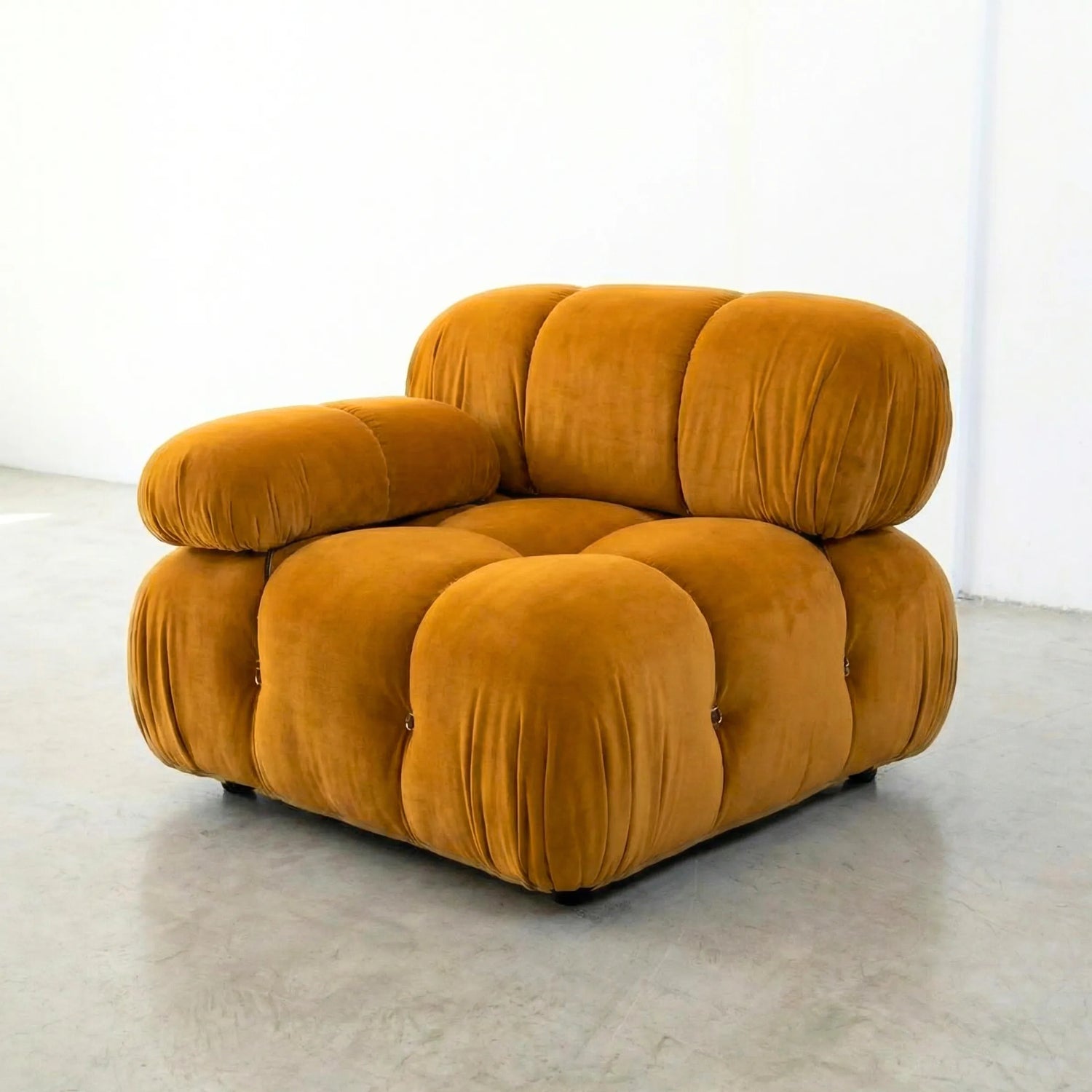 Camaleonda modular sofa section alternative with right armrest in mustard yellow velvet on a light gray floor with a white wall background