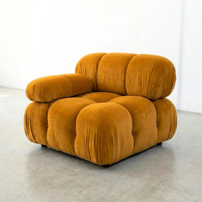 Camaleonda modular sofa section alternative with right armrest in mustard yellow velvet on a light gray floor with a white wall background