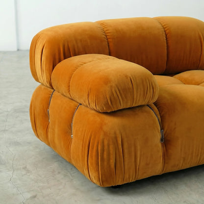 Camaleonda modular sofa section alternative with right armrest in mustard yellow velvet on a light gray floor with a white wall background