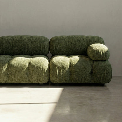 Camaleonda modular sofa dupe in green chenille with tufted upholstery in a minimalistic room with concrete floor and white walls