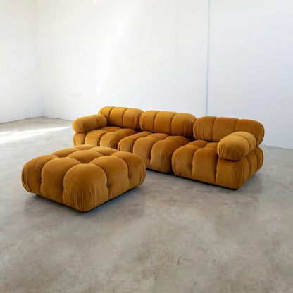 Camaleonda 3 seater modular sofa dupe in mustard velvet with tufted upholstery in a minimalistic room with concrete floor and white walls