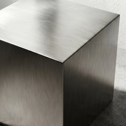 Detail view of the Chrome Steel Cube Table top and edge, highlighting the brushed chrome steel texture.