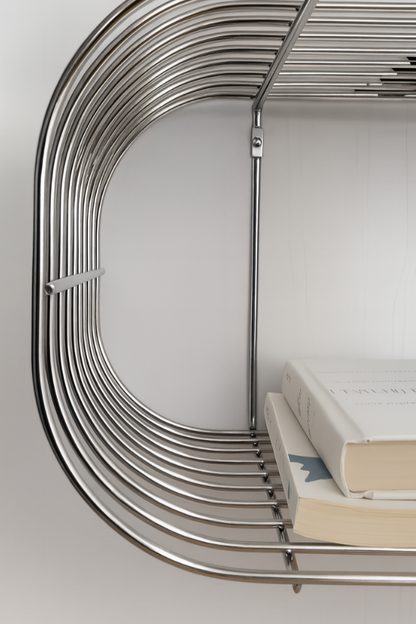 Metallic chrome floating wire circular shelf with books on a white background
