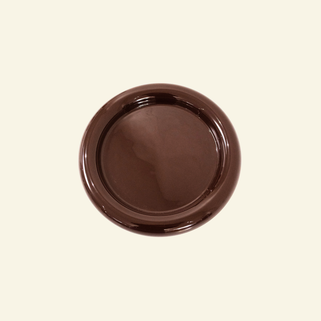 Brown ceramic plate on a beige background