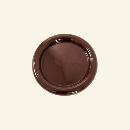 Brown ceramic plate on a beige background