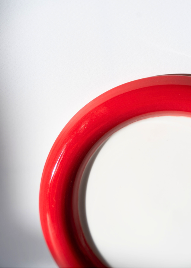 Close-up of the Two-Tone Chunky Ceramic Plate in red and white  a white background