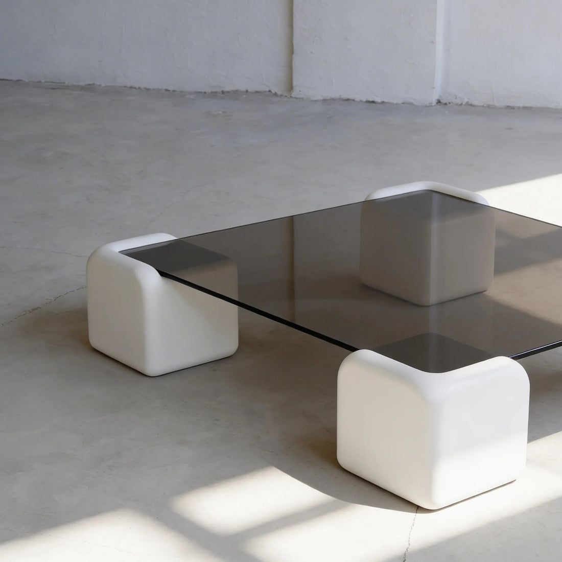 Elio Low Glass Coffee Table, a square glass coffee table with a low profile for modern lounge spaces, side view