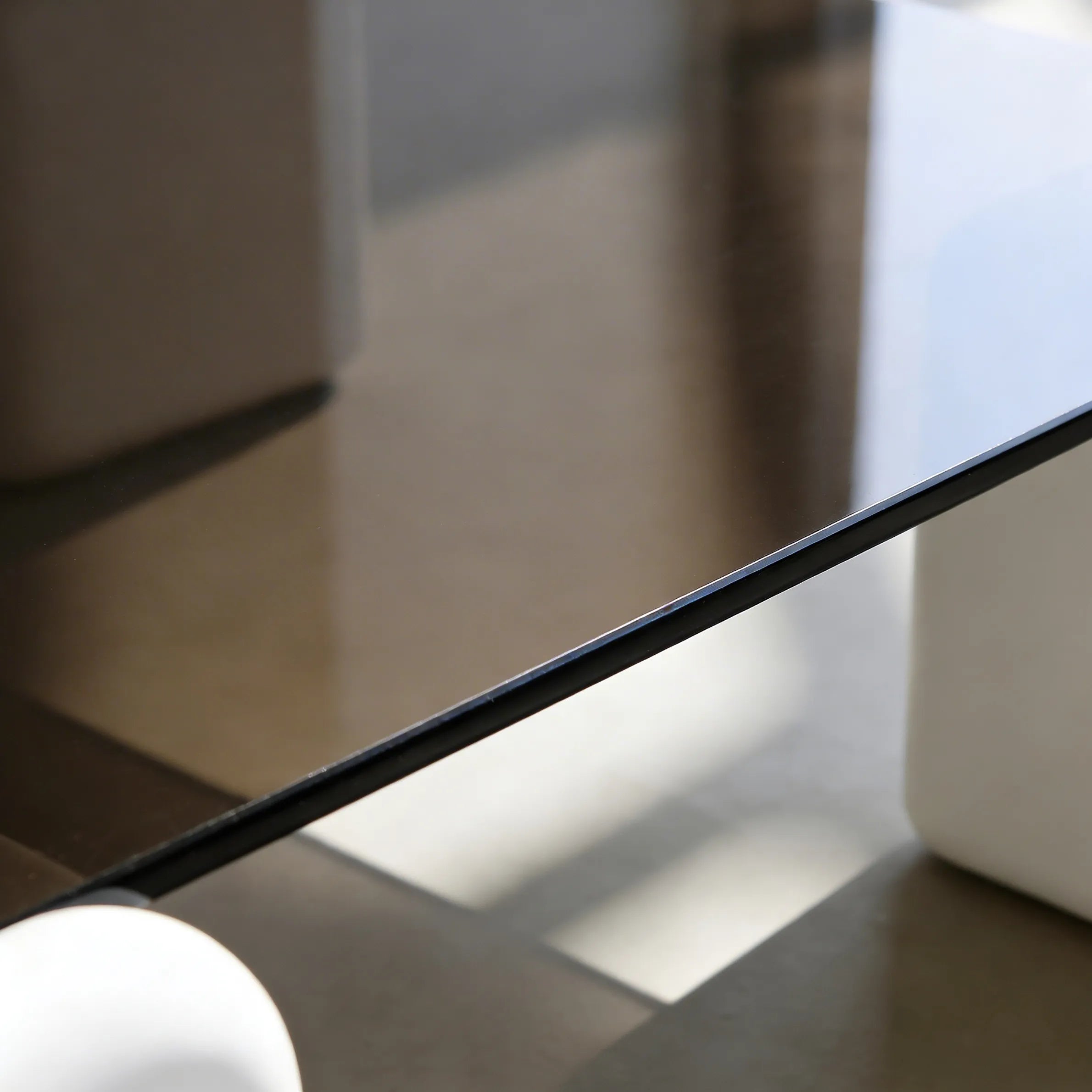 Elio Low Glass Coffee Table, a square glass coffee table with a low profile for modern lounge spaces, close-up detail