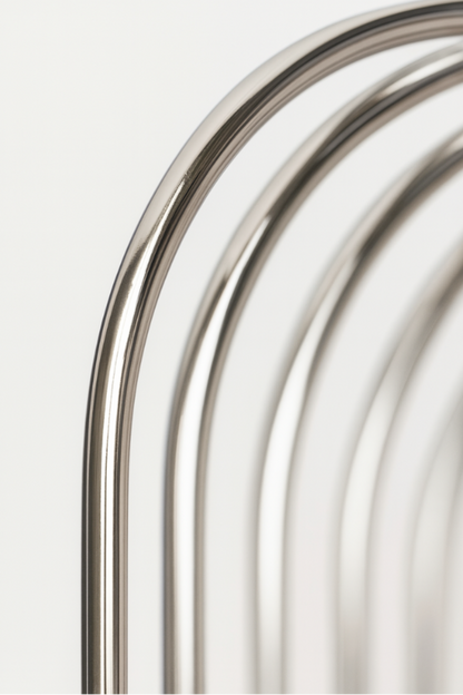 Close-up angled view of floating chrome wire wall shelf with shiny stainless steel finish