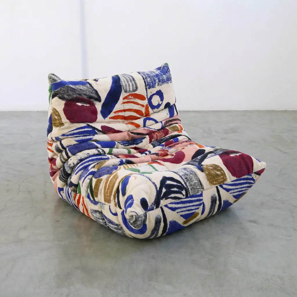 graffiti togo sofa chair inspired by ligne roste (michael ducaroy) on a plain floor