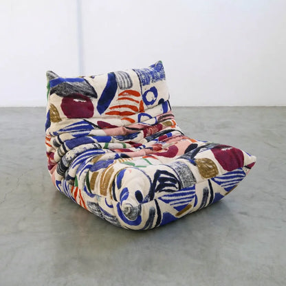 graffiti togo sofa chair inspired by ligne roste (michael ducaroy) on a plain floor