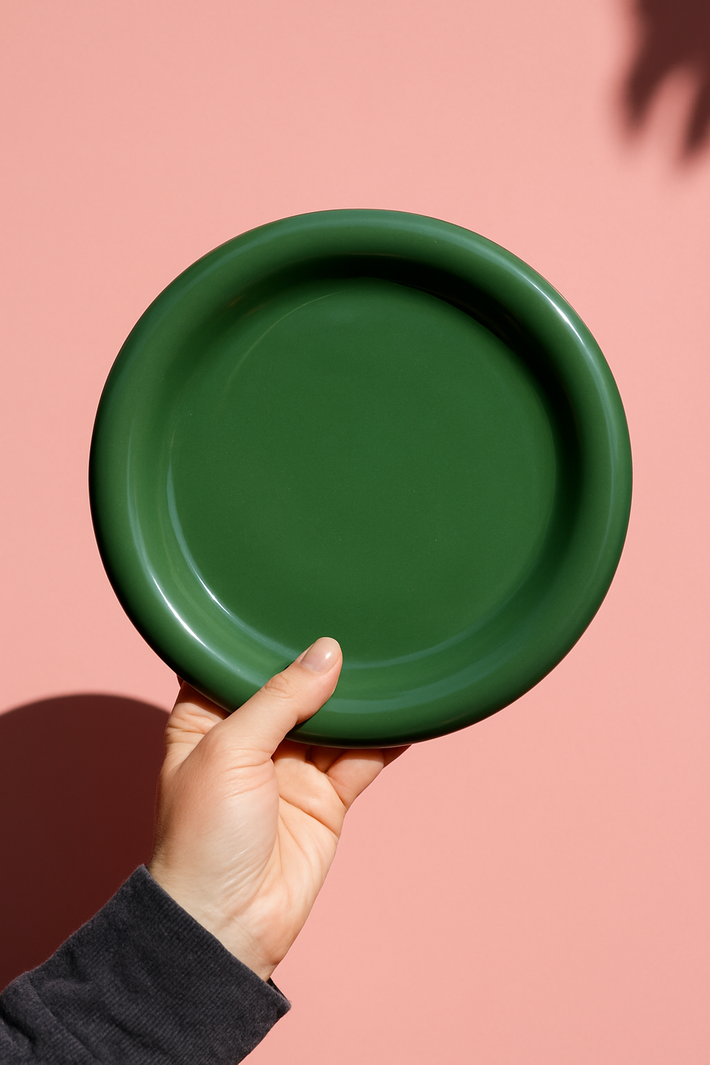 Close-up of cloud-shaped green chunky ceramic plate with glossy finish and rounded edges