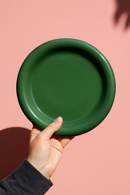 Close-up of cloud-shaped green chunky ceramic plate with glossy finish and rounded edges