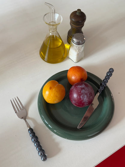 Cozy breakfast setup with Gustaf Westman–inspired green chunky ceramic plate on the table