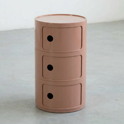 Kartell Componibili dupe round modular storage unit in glossy clay brown plastic with three tiers on concrete floor in white studio setting