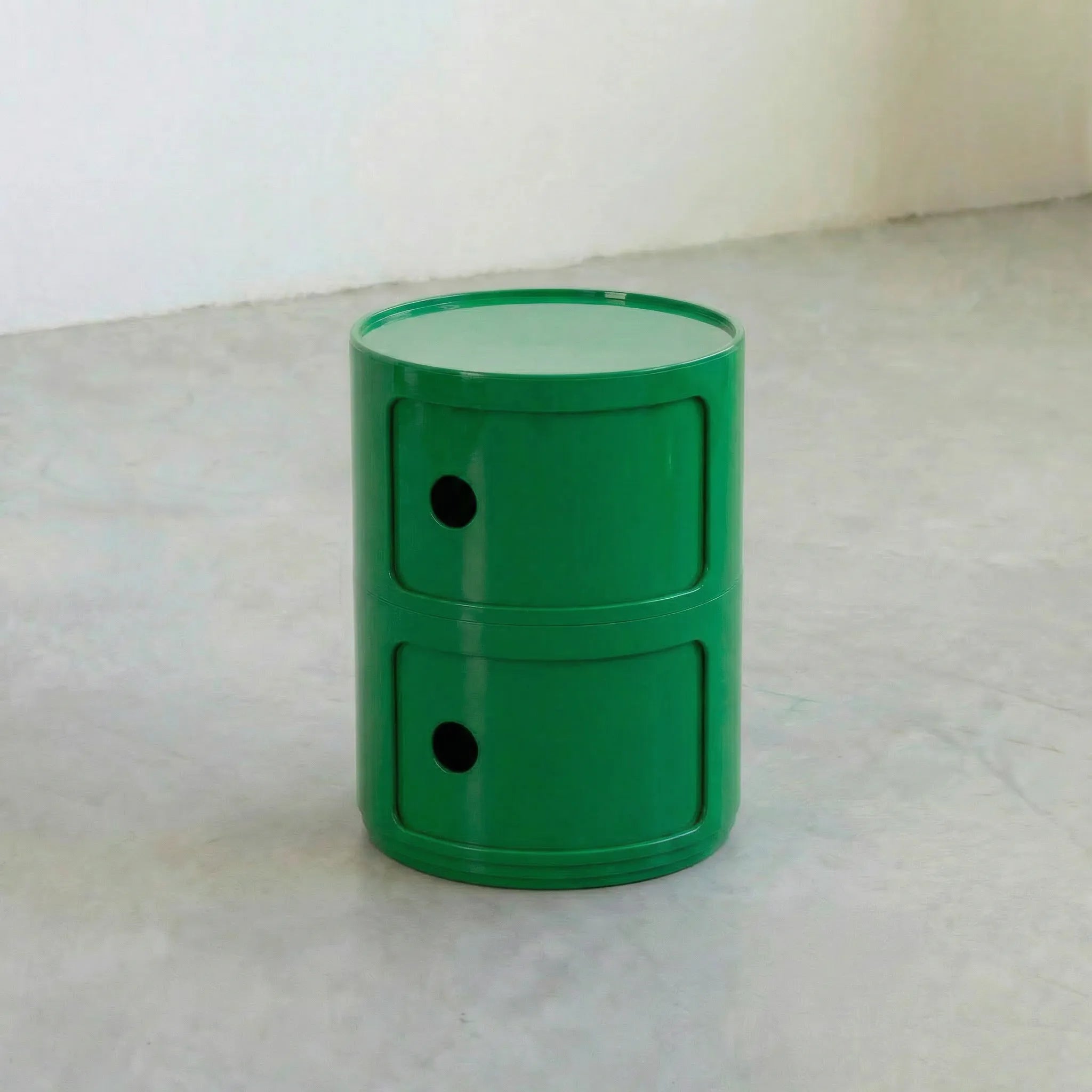 Green kartell componibili dupe storage unit with two drawers on a light gray surface.