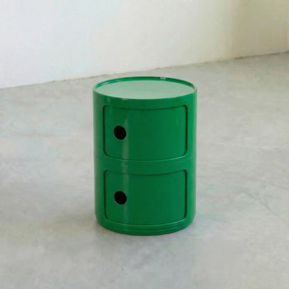 Green kartell componibili dupe storage unit with two drawers on a light gray surface.