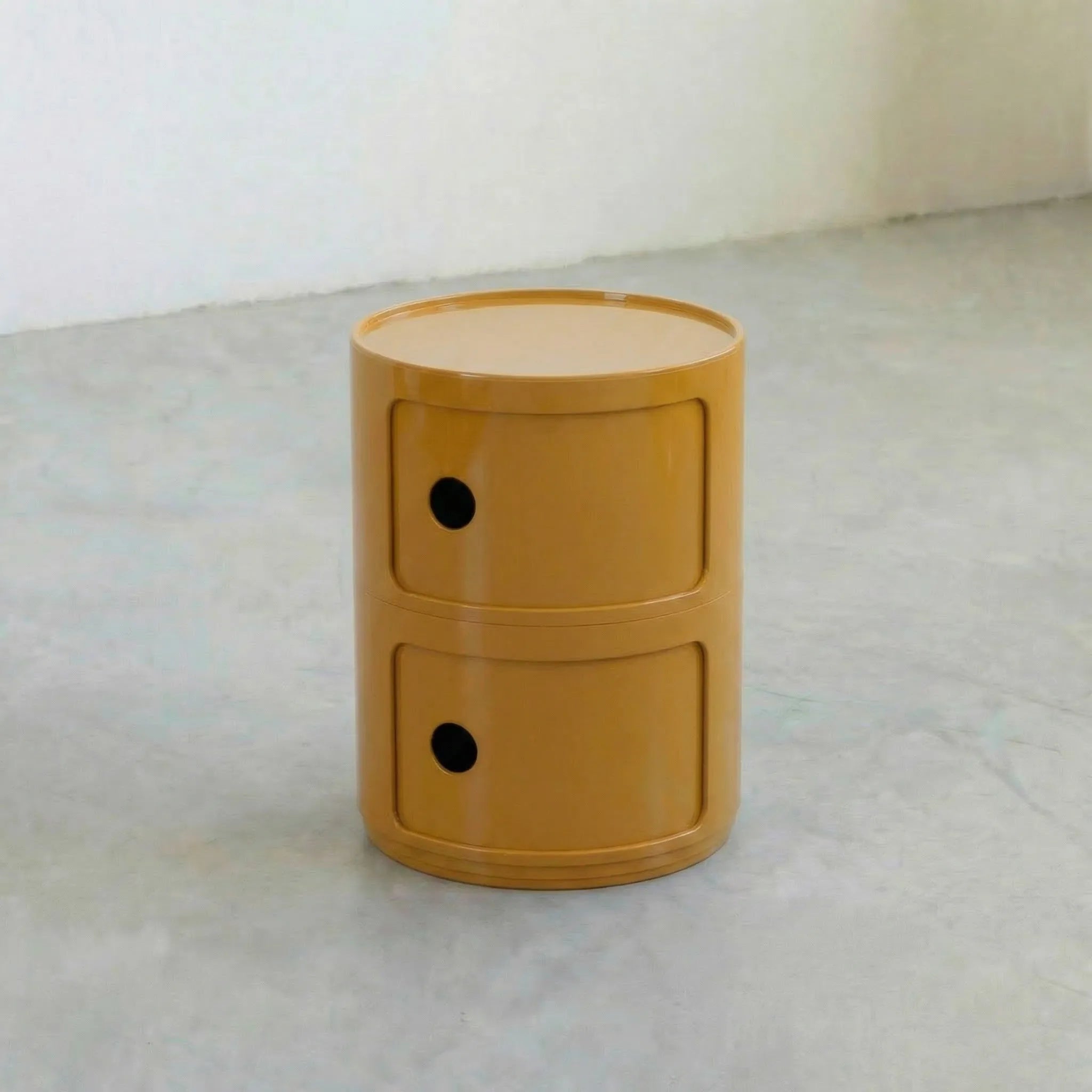 Mustard Yellow glossy round modular storage unit, Kartell Componibili dupe with two tiers in minimalist concrete studio