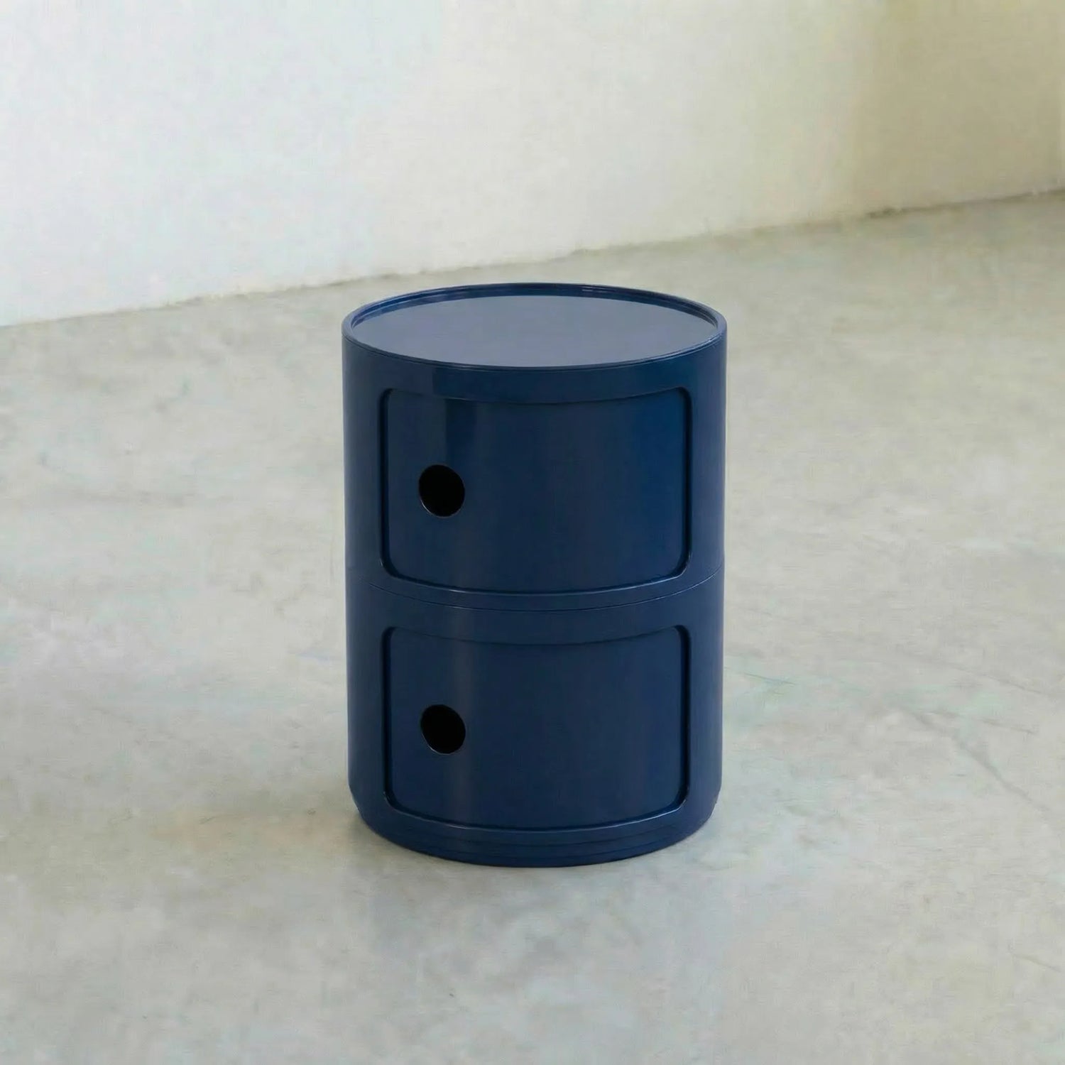 Navy Blue glossy round modular storage unit, Kartell Componibili dupe with two tiers in minimalist concrete studio