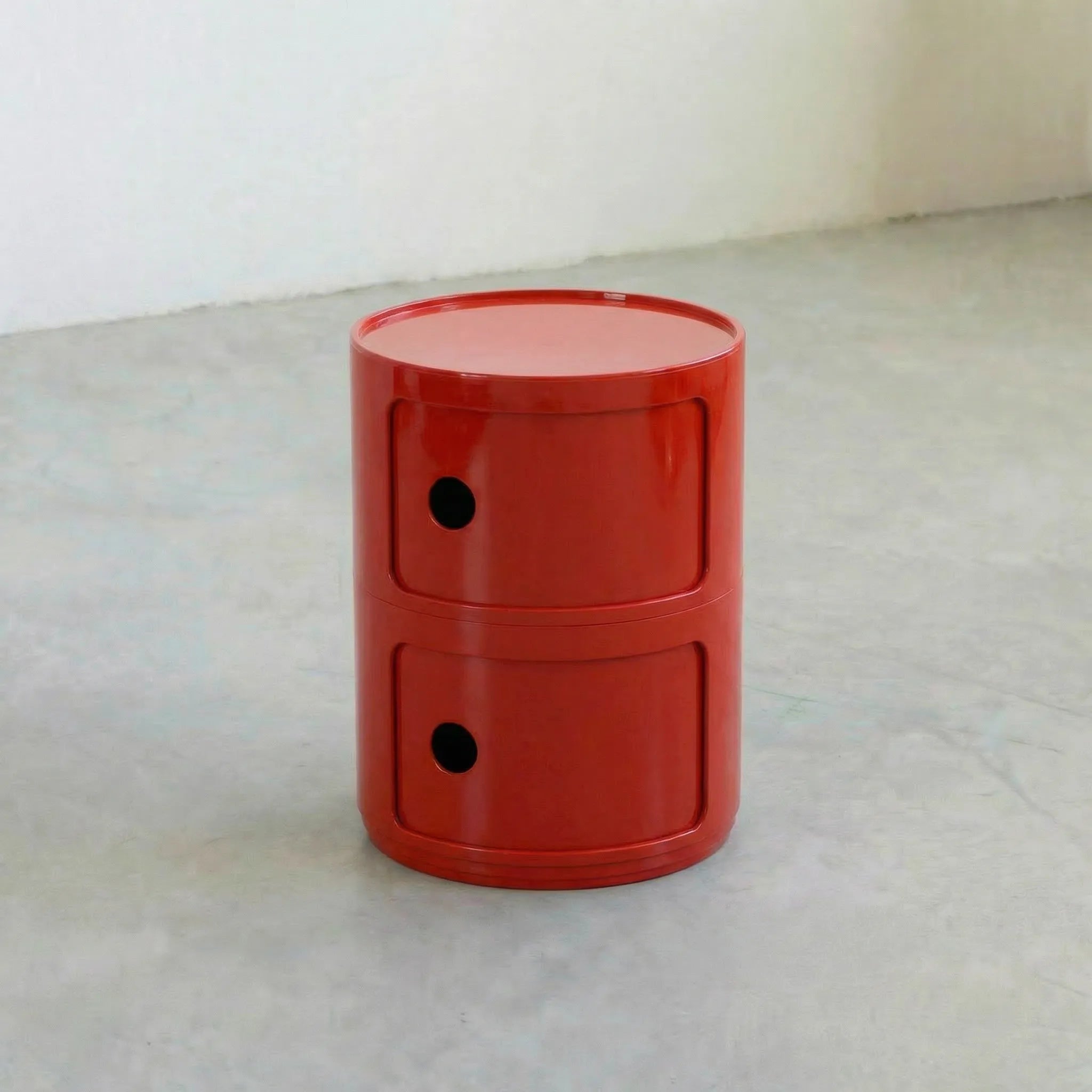 Red glossy round modular storage unit, Kartell Componibili dupe with two tiers in minimalist concrete studio