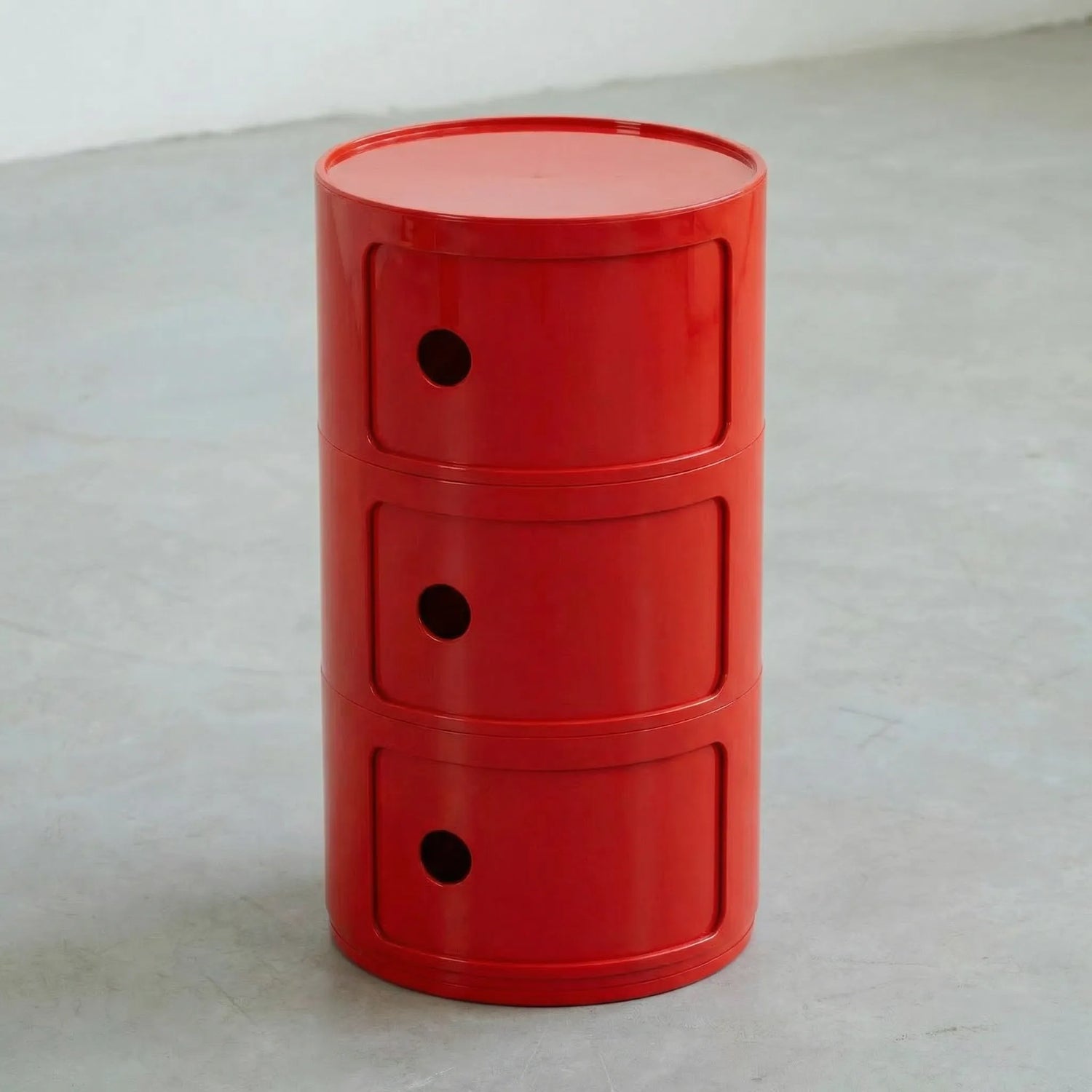 Red glossy round modular storage unit, Kartell Componibili dupe with three tiers in minimalist concrete studio