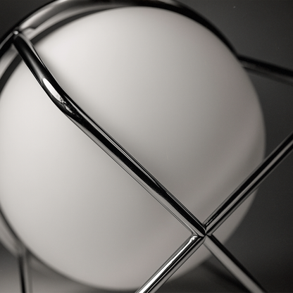 Close-up of ball table lamp base – durable iron frame and acrylic globe design.