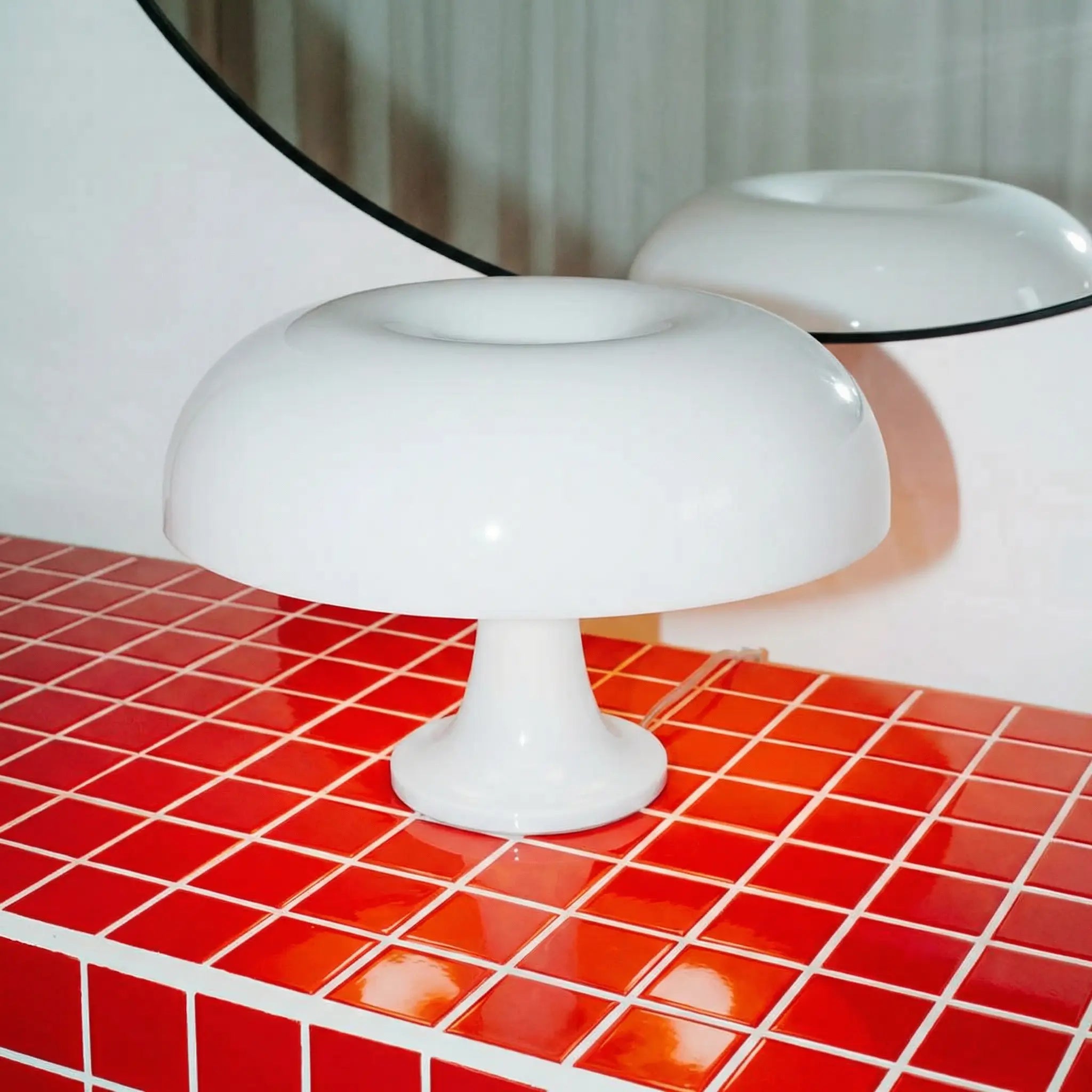 White nesso lamp dupe on a red tiled surface