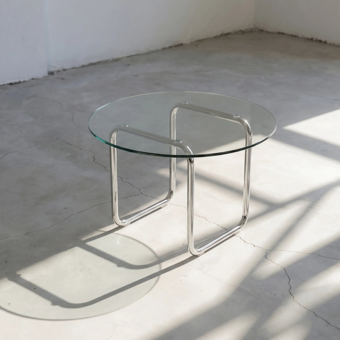 Orbit Round Glass Coffee Table, a round glass coffee table with a sculptural base for contemporary living rooms, side view