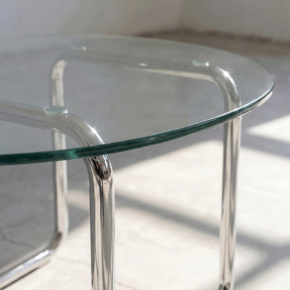 Orbit Round Glass Coffee Table, a round glass coffee table with a sculptural base for contemporary living rooms, angled view