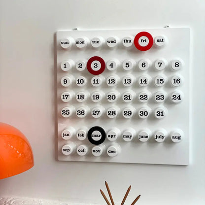 White Perpetual Ring-a-Date Calendar dupe on the wall