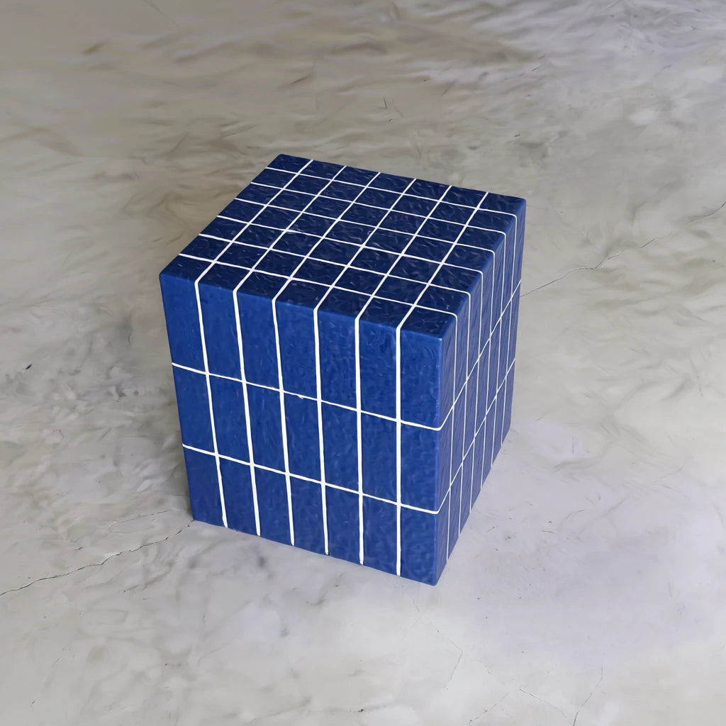Sapphire blue cube side table shown on a marbled floor from an angled front view.