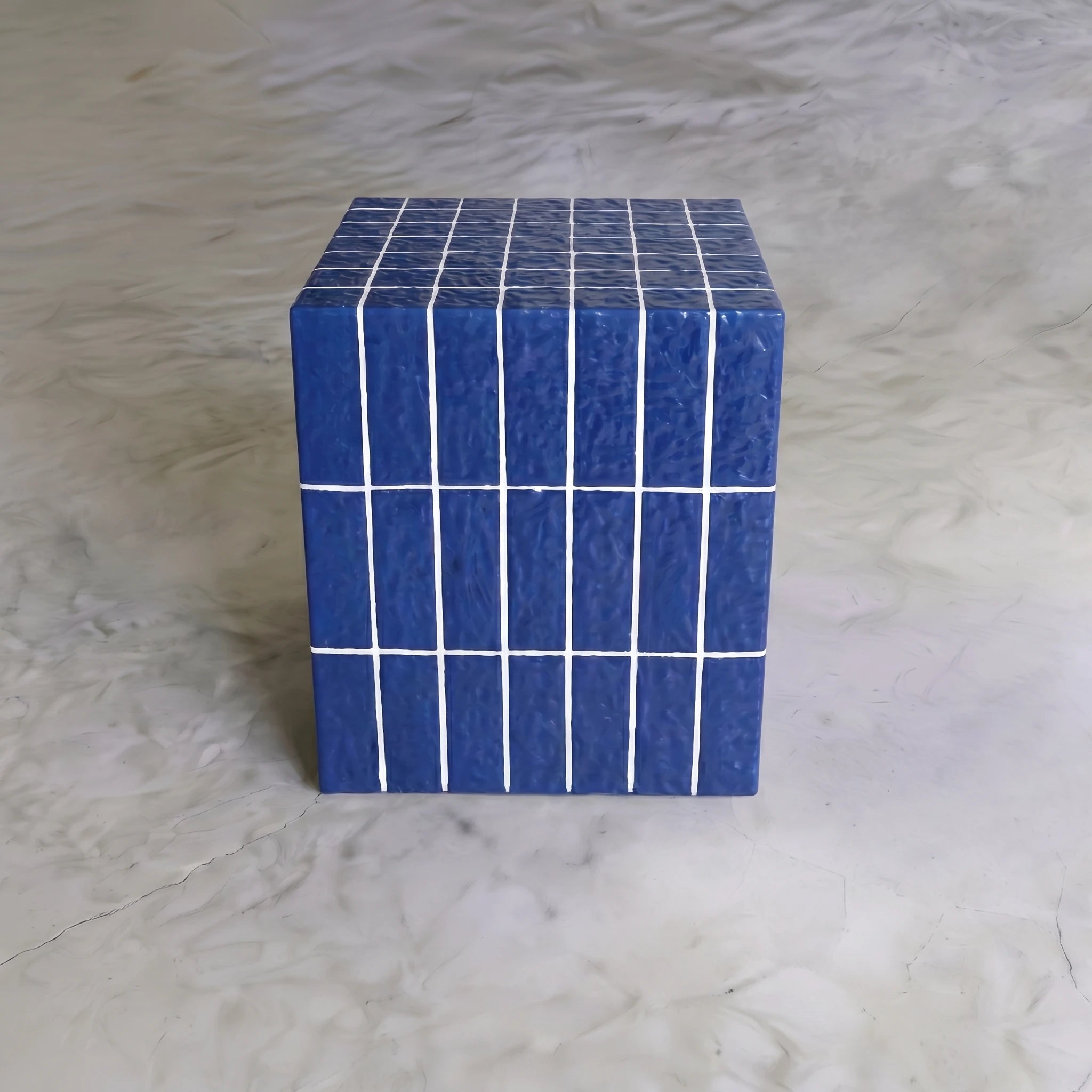 Front view of the blue ceramic-look cube side table styled as a modern accent table.