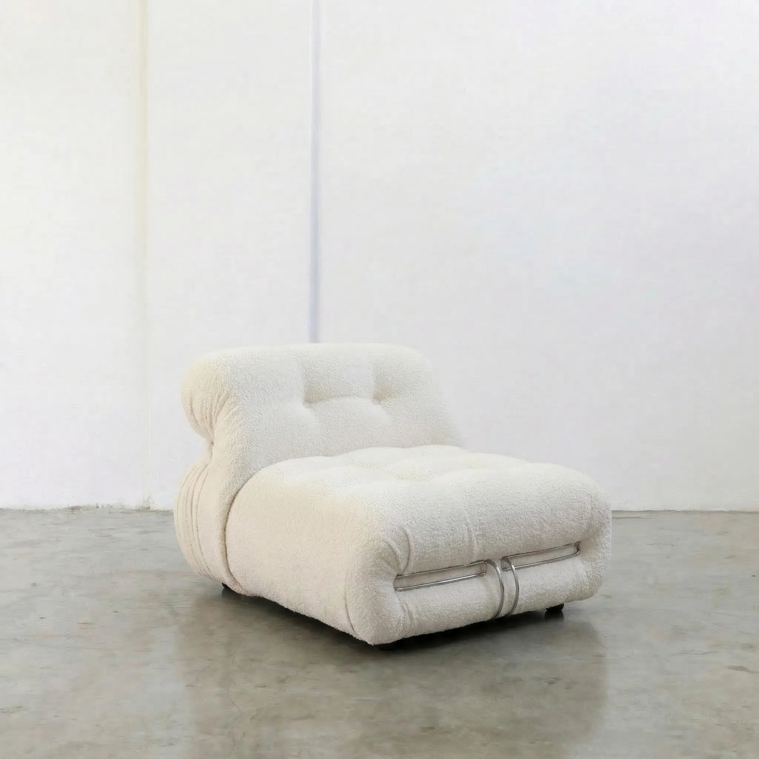 Soriana Chair Dupe in white boucle on a gray floor with a white wall background