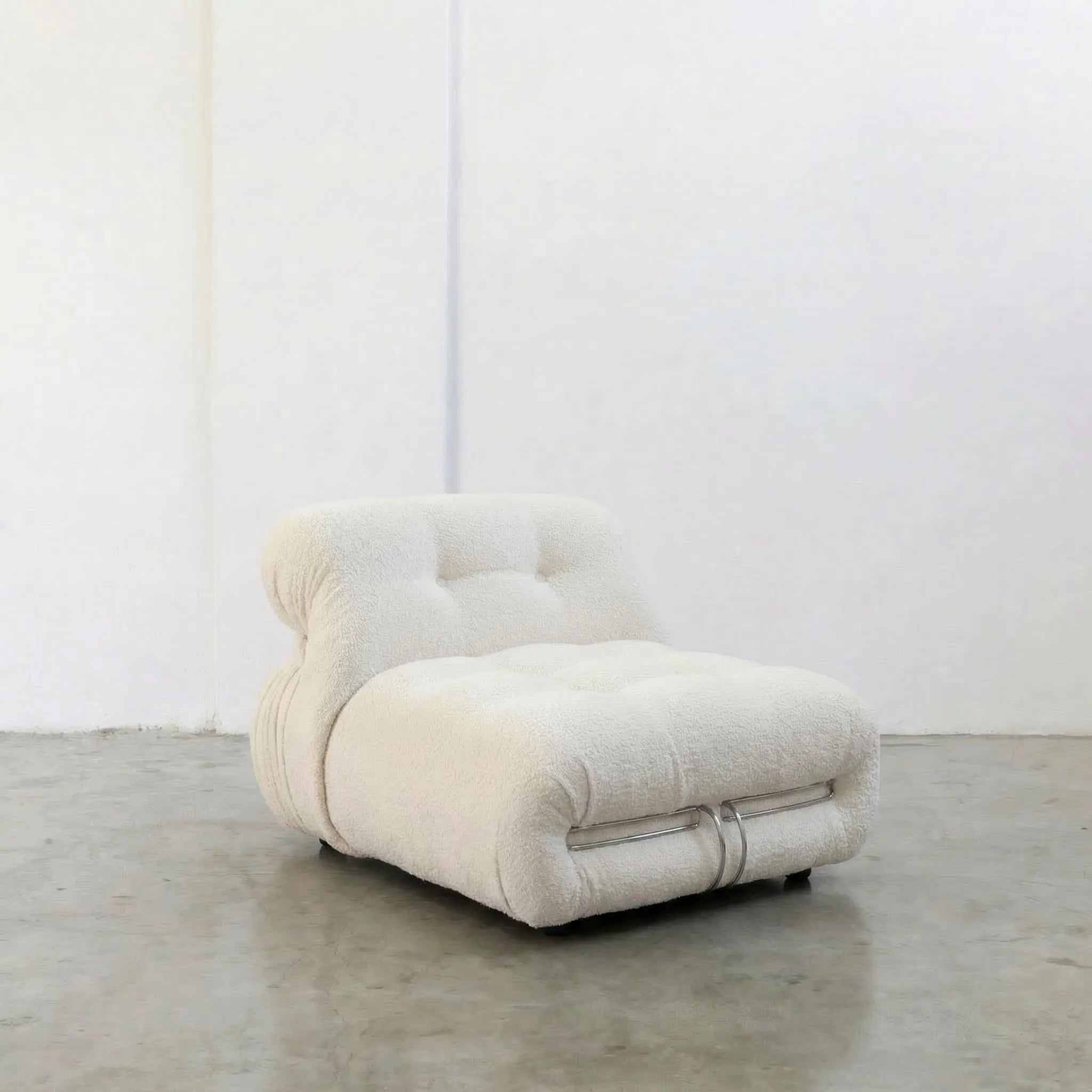 Soriana Chair Dupe in white boucle on a gray floor with a white wall background