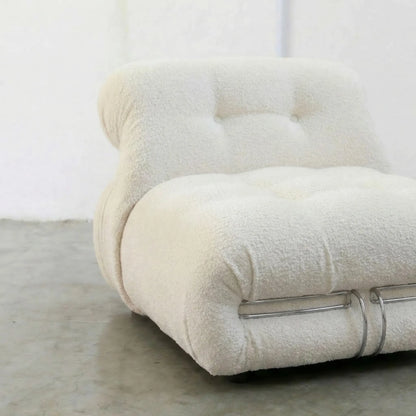 Close-up of a textured Soriana Chair Dupe in white boucle with metallic steel clamps on a light background