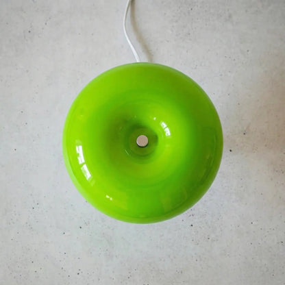 The Top of the Space age table lamp in green showing rounded glass sphere on a concrete floor.