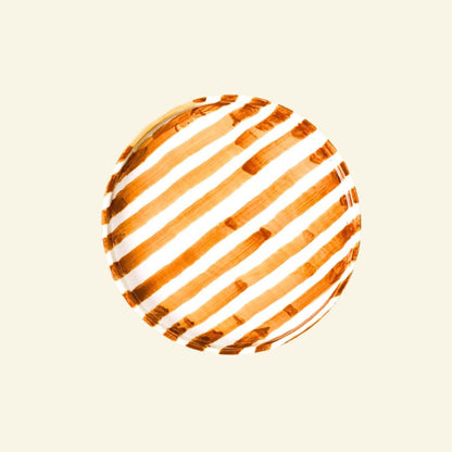 Orange-White striped artisan handmade ceramic dinner plate on a beige background