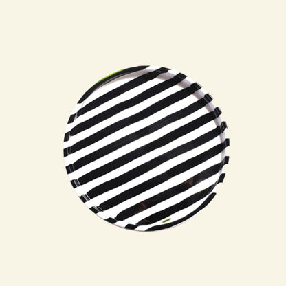 Black-White striped artisan handmade ceramic dinner plate on a beige background