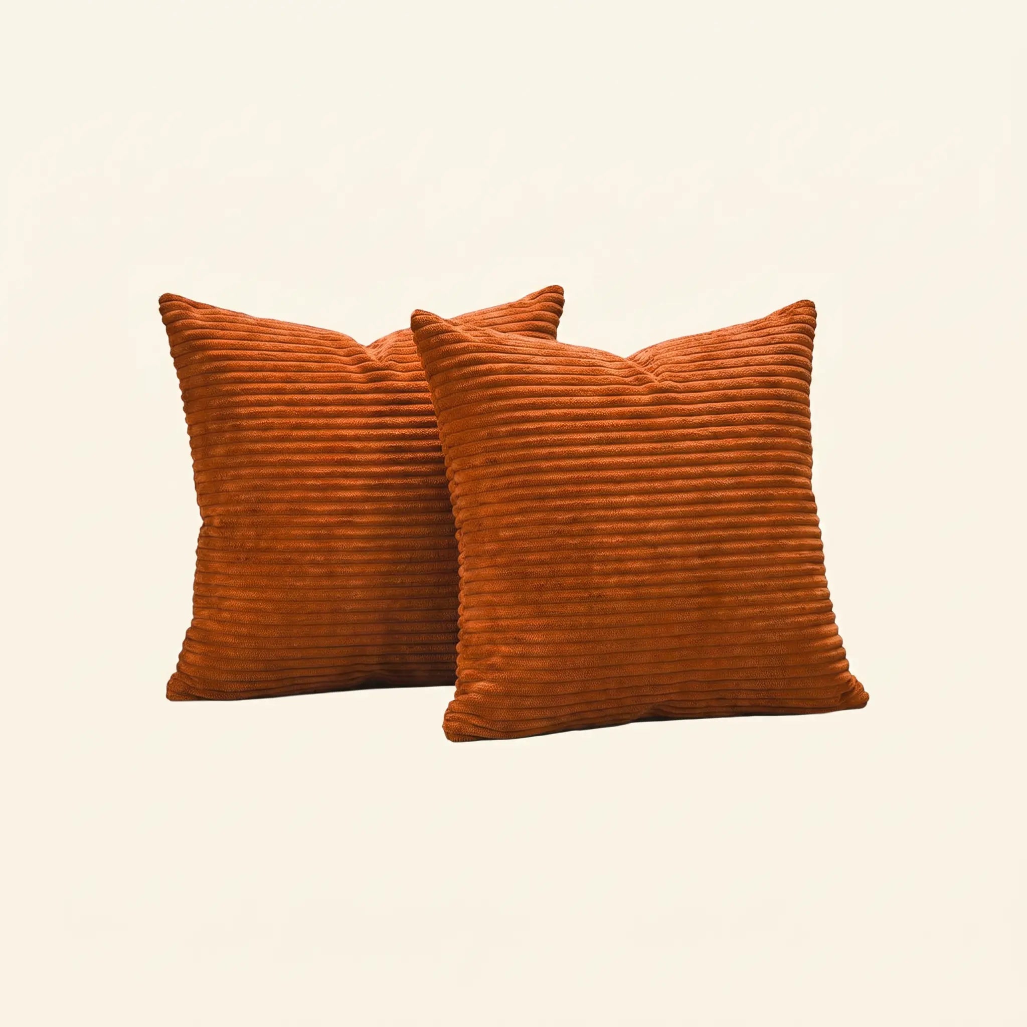 Two square orange-brown corduroy throw pillows with a ribbed texture, displayed against a solid off-white background.