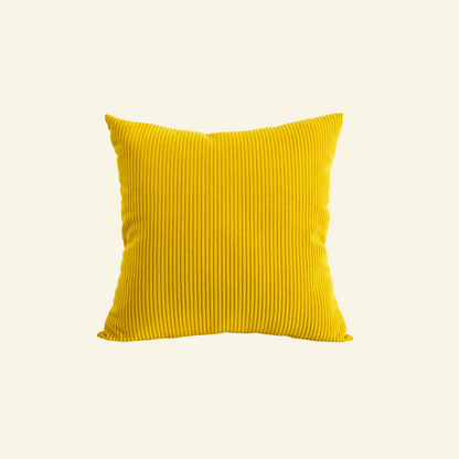 Yellow  corduroy pillow on a light beige background