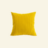 Yellow  corduroy pillow on a light beige background