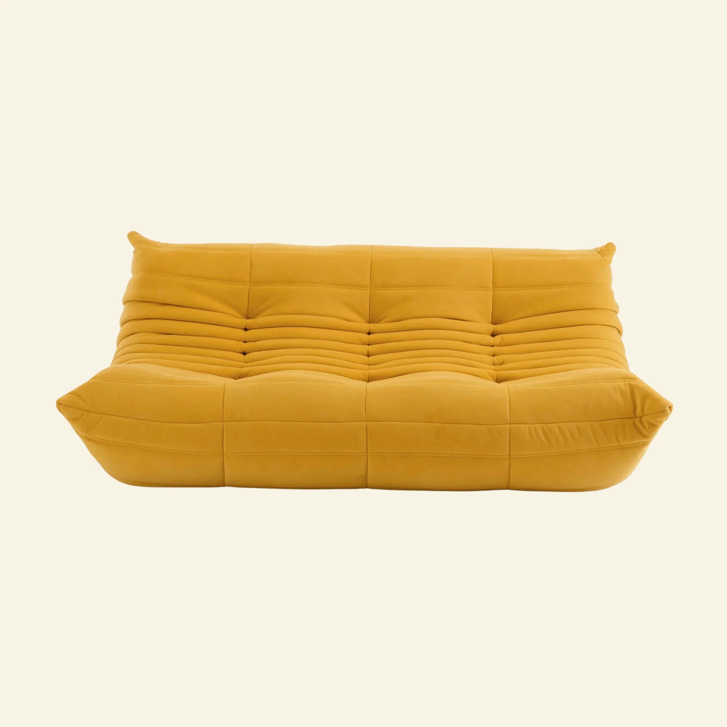 togo sofa dupe 3-seater in yellow velvet on a warm neutral studio background by vibehaus