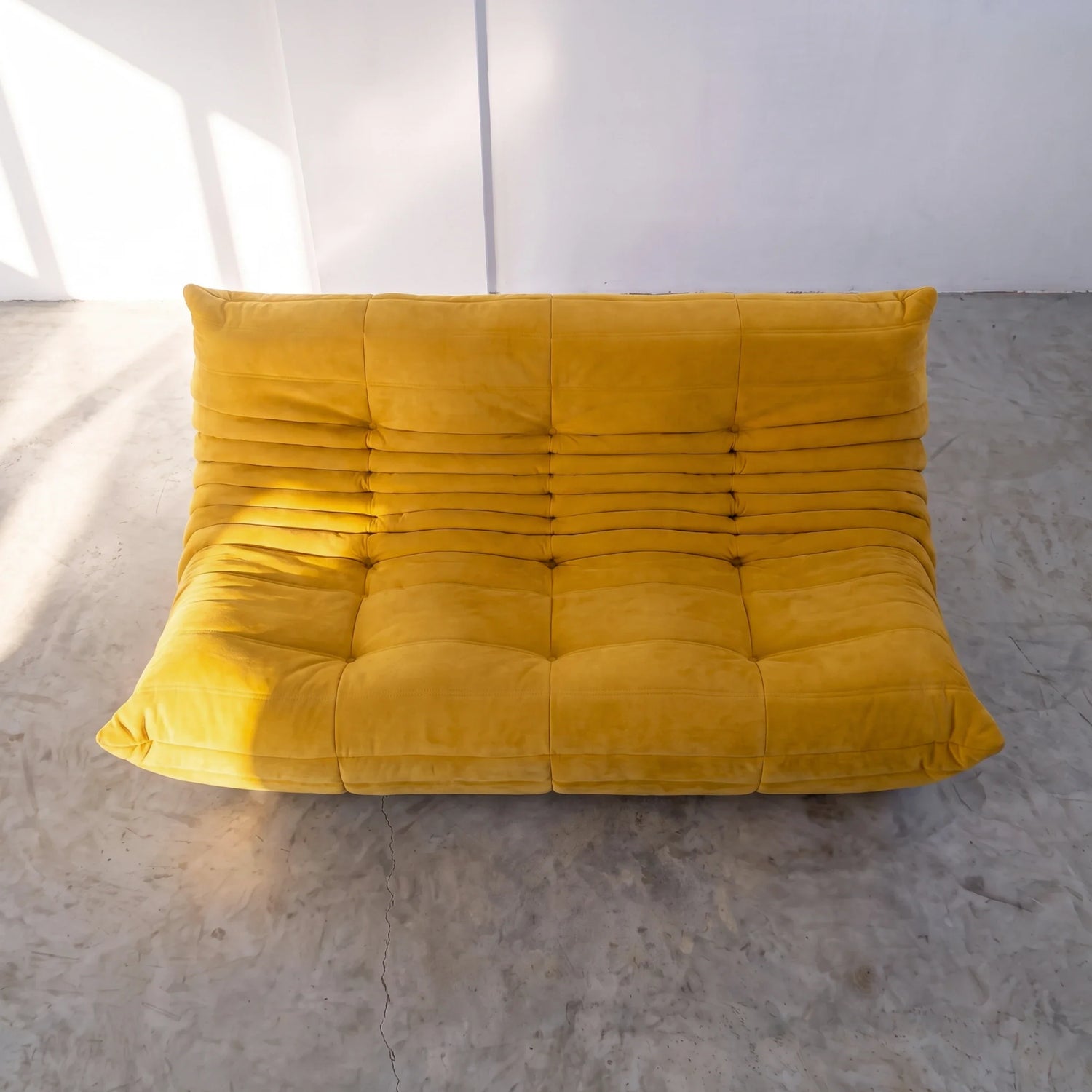 togo sofa dupe 3-seater in yellow velvet viewed from above in a bright studio by vibehaus