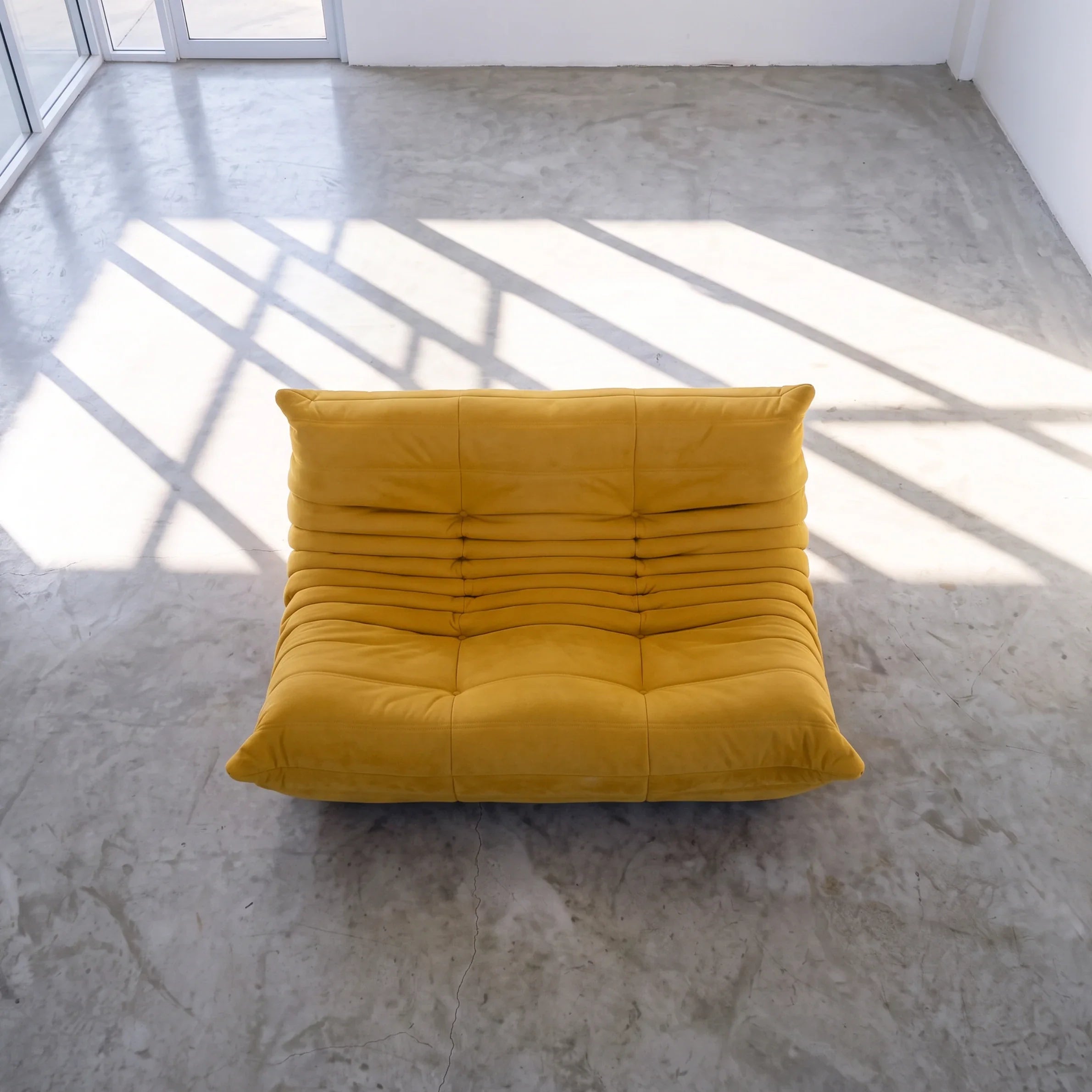 togo sofa dupe in yellow velvet viewed from above in a bright studio by vibehaus