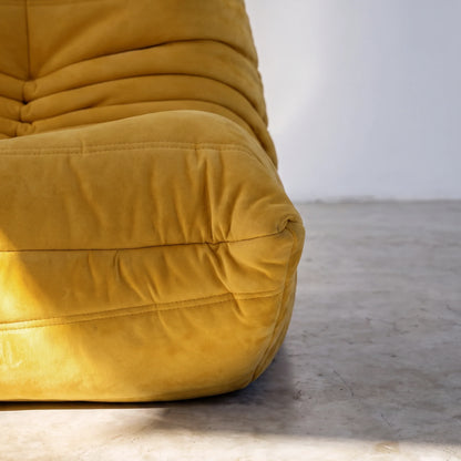 togo sofa dupe close-up showing the yellow velvet upholstery and curved seat detail by vibehaus